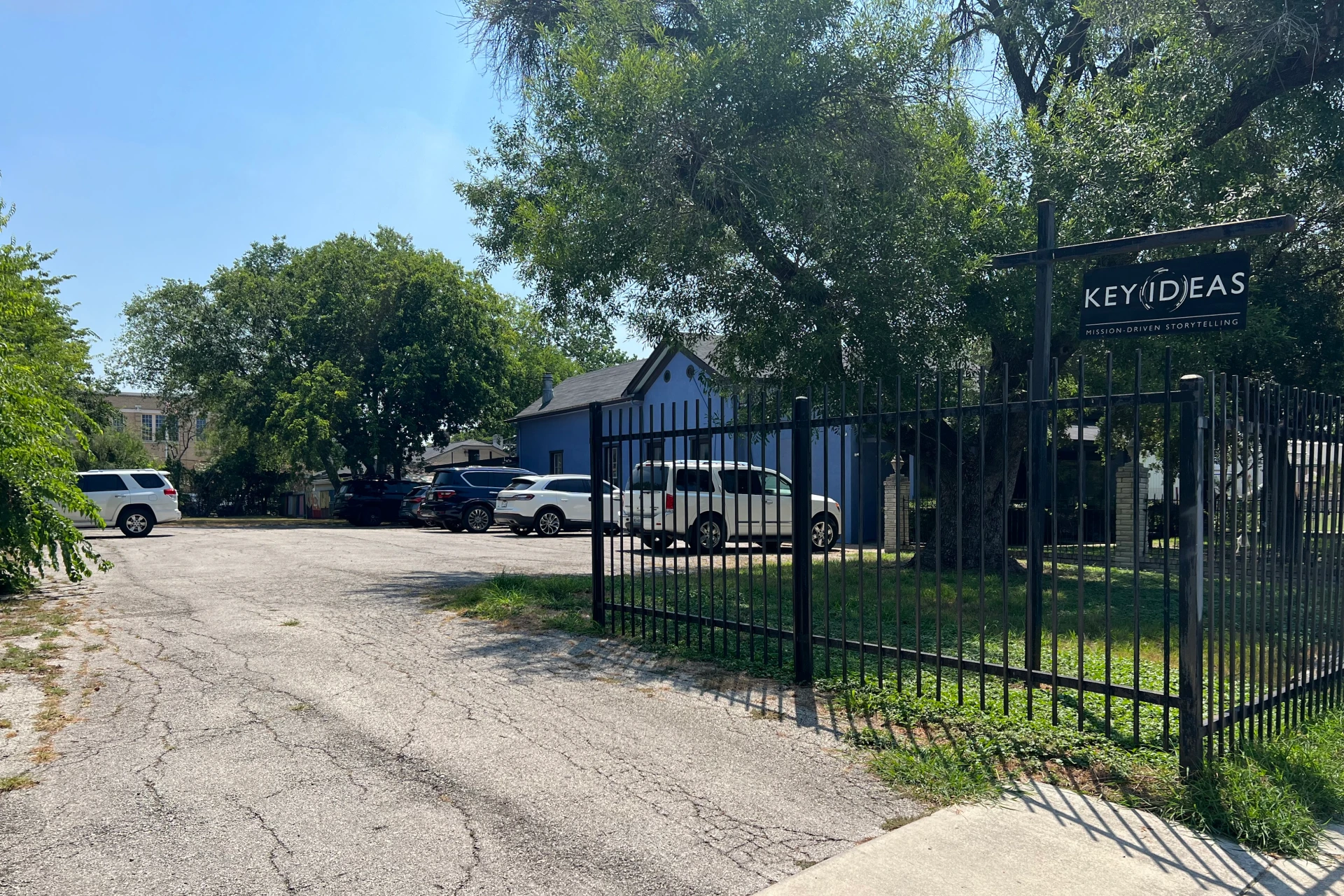 Parking area at San Antonio II office with building and gated entrance