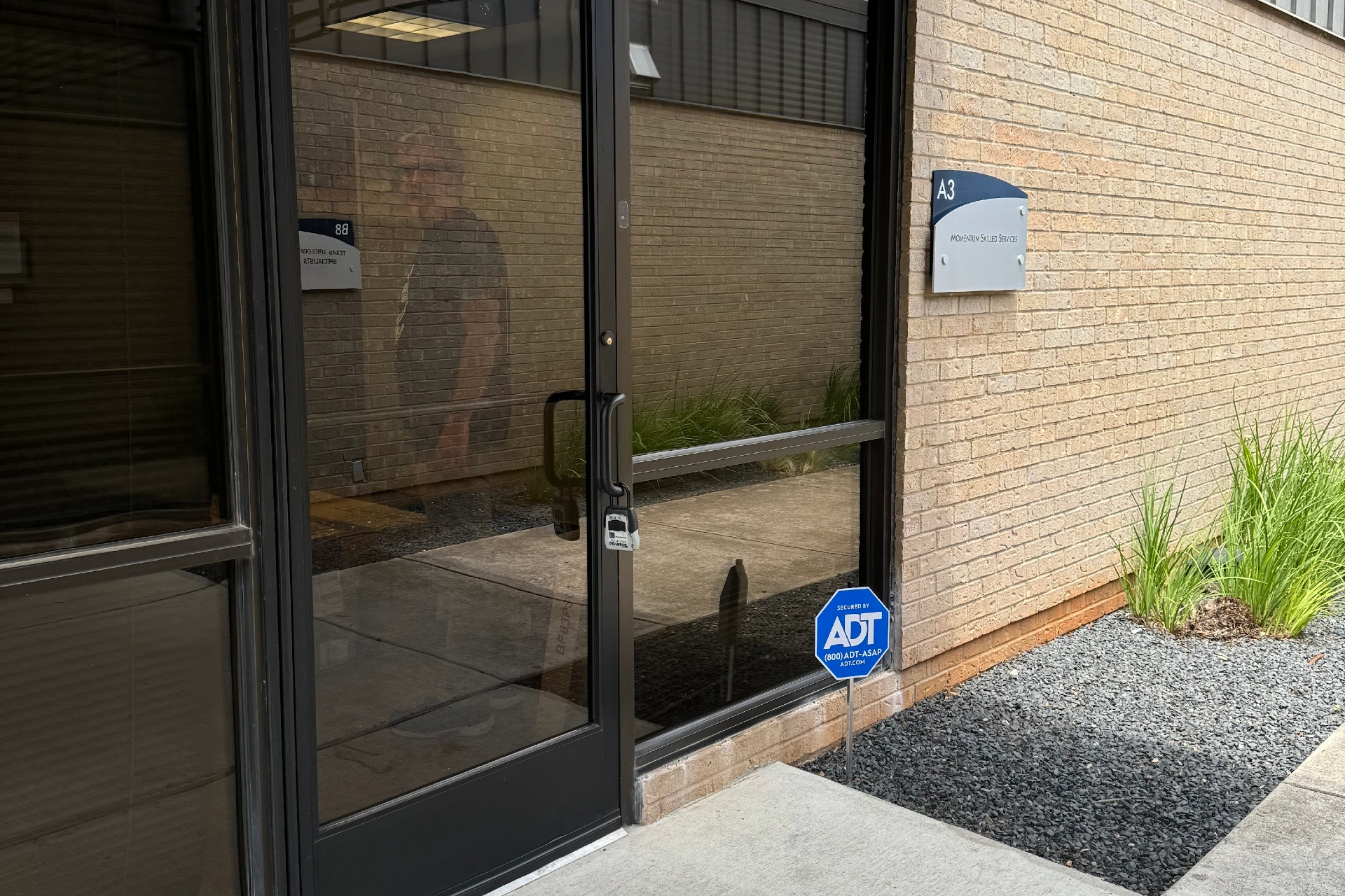 Entrance to Austin office building with glass door and exterior signage