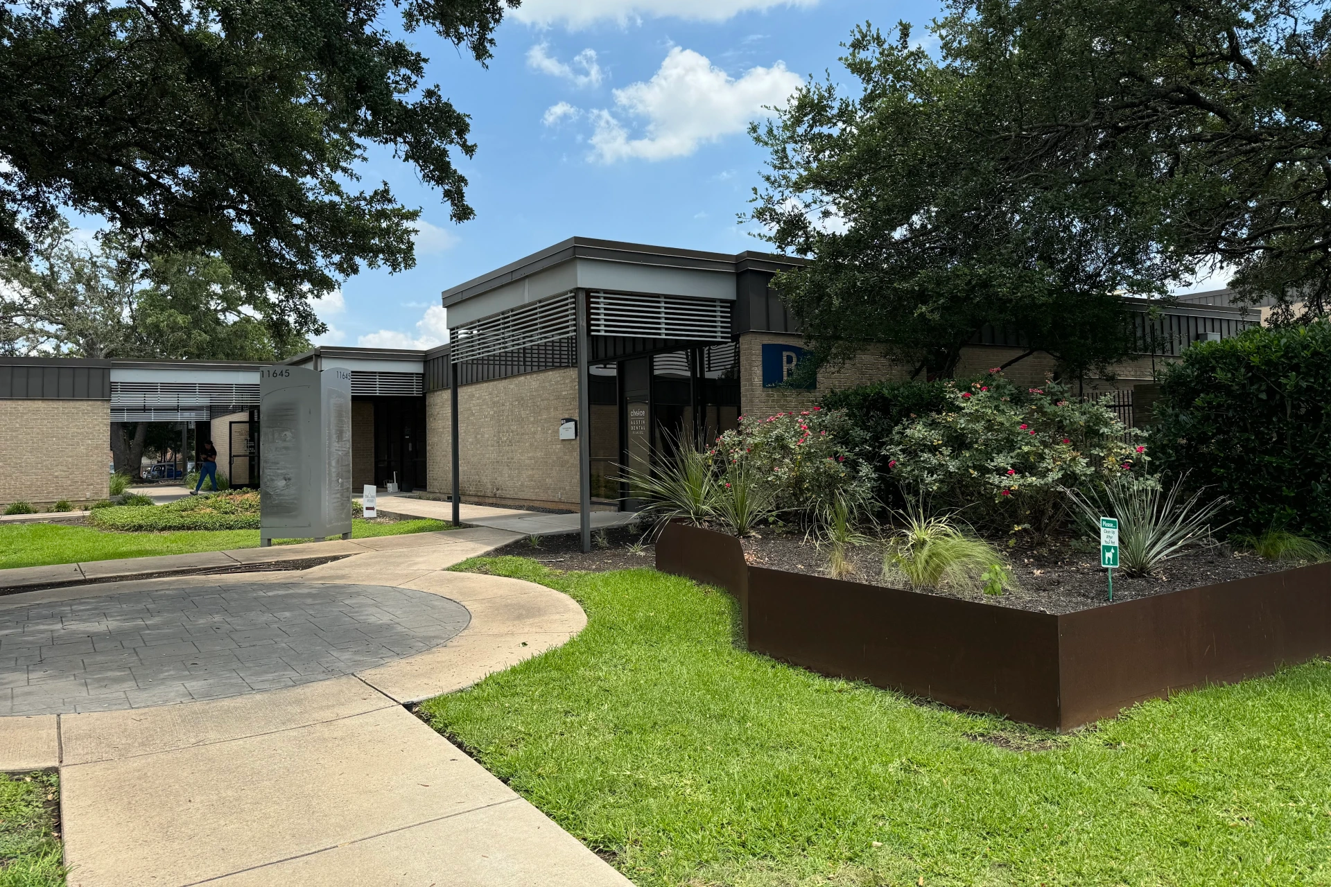 Exterior view of Austin office building with landscaping and walkway