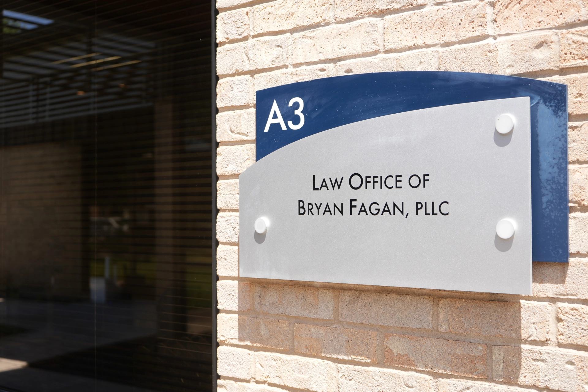 Austin office location sign for Law Office of Bryan Fagan PLLC on building exterior