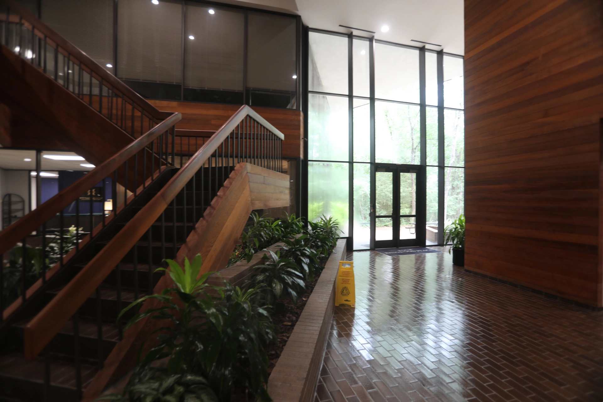 Office lobby seating area with chairs and table near large windows