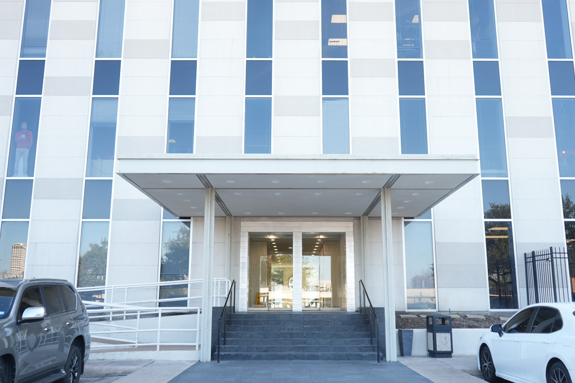 Exterior of River Oaks office building with entrance and parking area