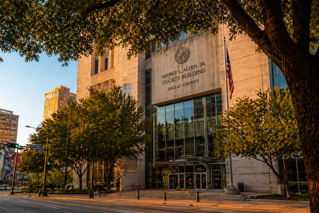 Wide-angle view of the George L. Allen Sr. Courts Building in Dallas at sunset, representing where divorce cases are filed in Dallas County