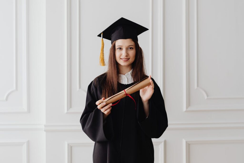 a young woman holding a diploma