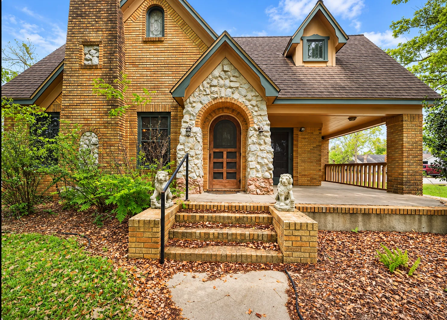 Exterior of the Angleton Office featuring a brick-and-stone entrance, covered porch, and front steps.