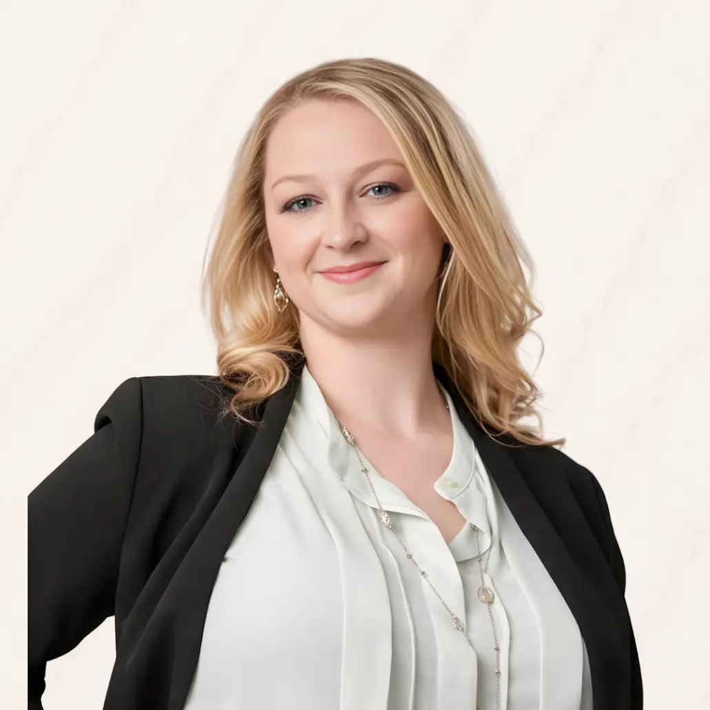 Professional headshot of Chelsea Wojcik smiling in a black blazer and white blouse.